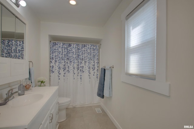 full bathroom with toilet, visible vents, vanity, baseboards, and tile patterned floors