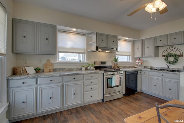 kitchen with dishwasher, dark wood-style floors, under cabinet range hood, stainless steel range with gas cooktop, and a sink