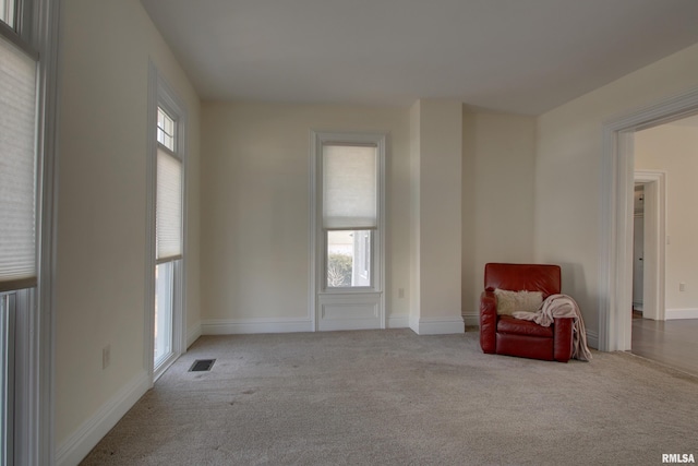 sitting room featuring carpet, visible vents, and baseboards