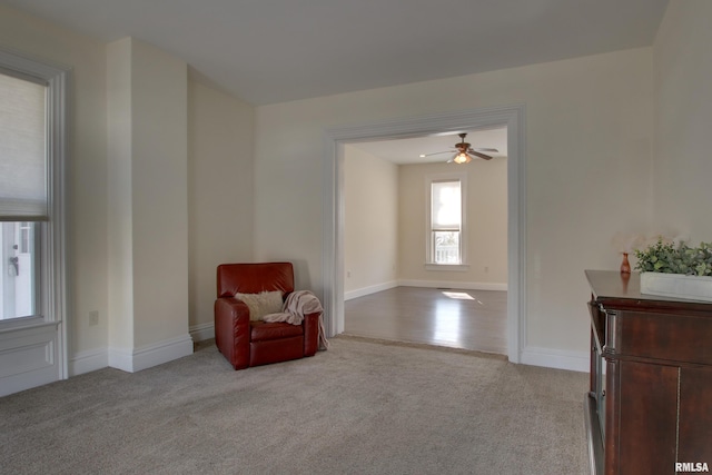 sitting room with carpet and baseboards