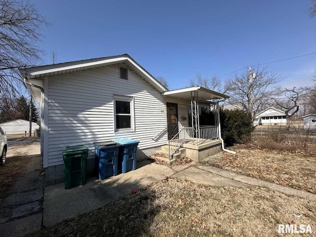 back of house featuring a porch