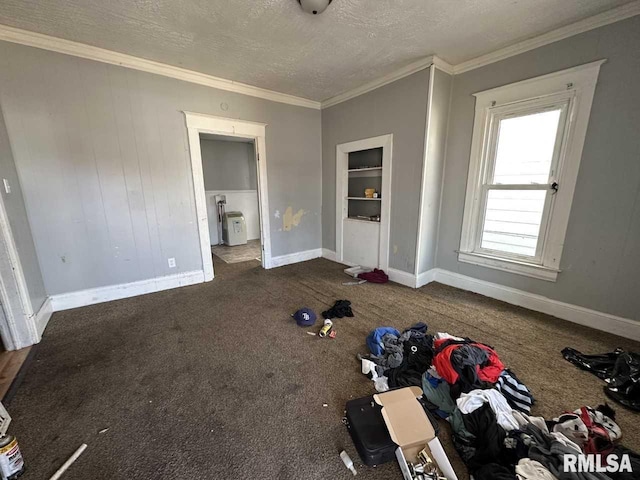 unfurnished bedroom with carpet floors, a textured ceiling, baseboards, and crown molding