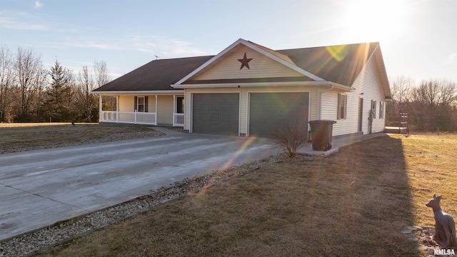 view of front of home with a garage, covered porch, and concrete driveway