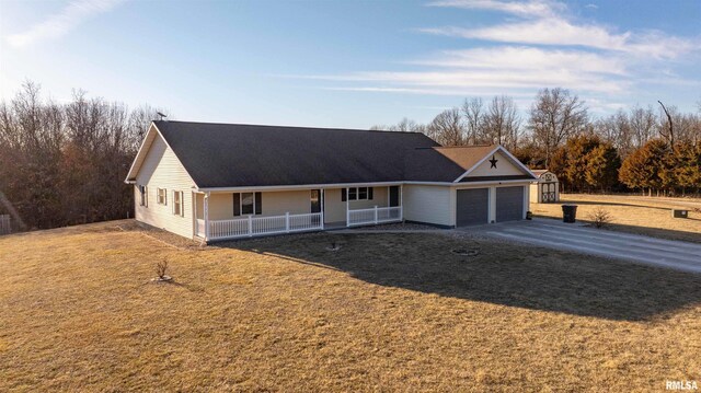 view of front of house with a porch, a front yard, driveway, and a garage