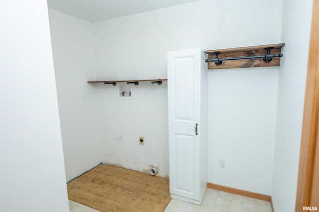 clothes washing area featuring laundry area, baseboards, washer hookup, and hookup for an electric dryer