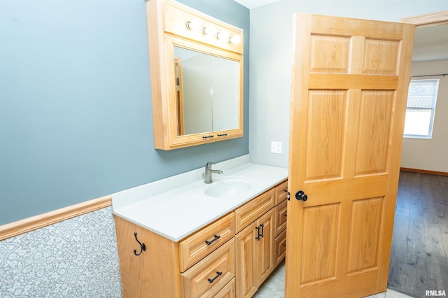 bathroom featuring baseboards and vanity