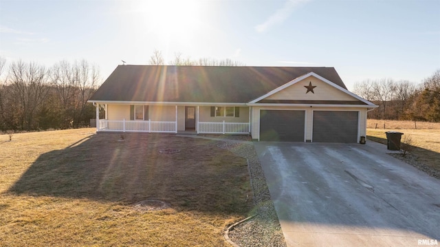 view of front of property with driveway, a garage, a porch, and a front yard