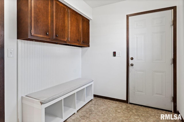 mudroom with light floors and baseboards