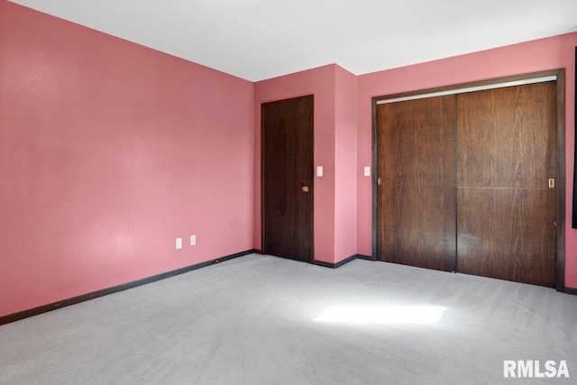 unfurnished bedroom featuring a closet, carpet, and baseboards