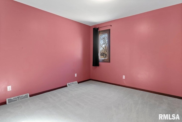 unfurnished room with carpet flooring, visible vents, and baseboards