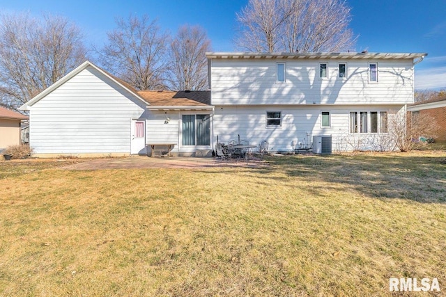 rear view of house with a lawn and central air condition unit