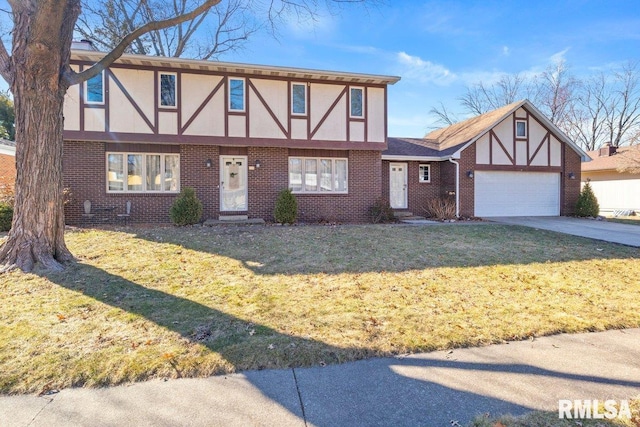 tudor home featuring an attached garage, a front yard, and brick siding