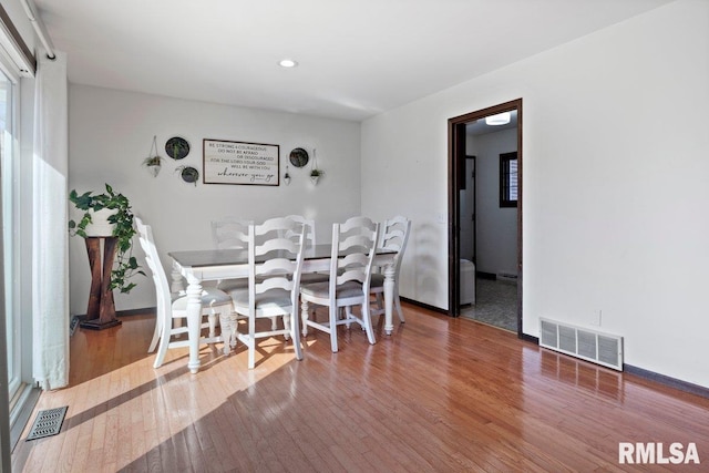 dining room with visible vents and hardwood / wood-style floors