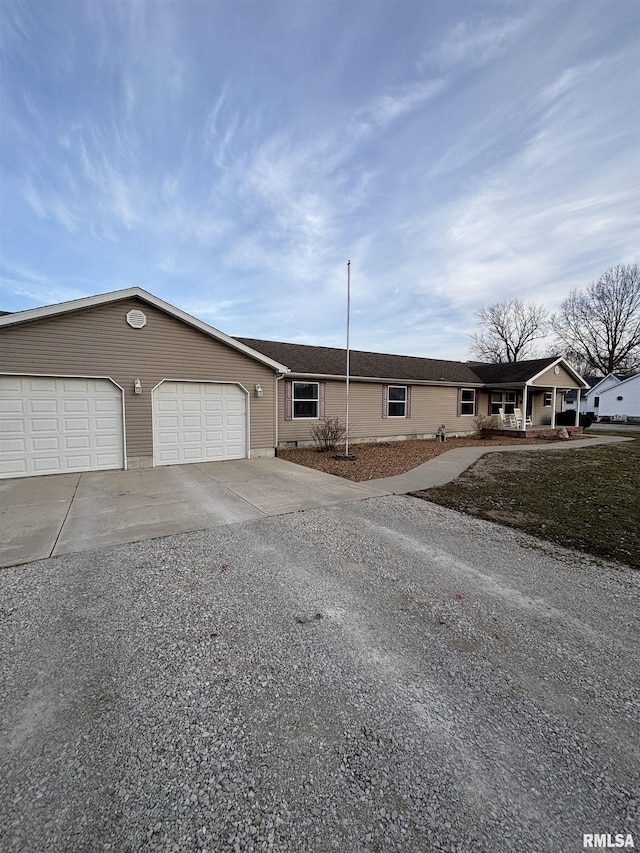 ranch-style home with a garage and concrete driveway