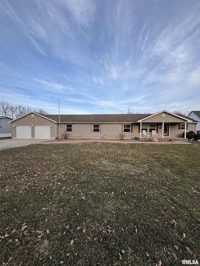 ranch-style house featuring a garage, covered porch, and a front lawn