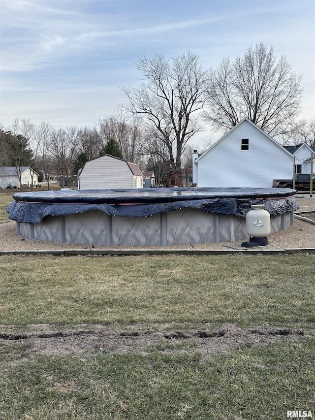 view of pool with a covered pool and a lawn