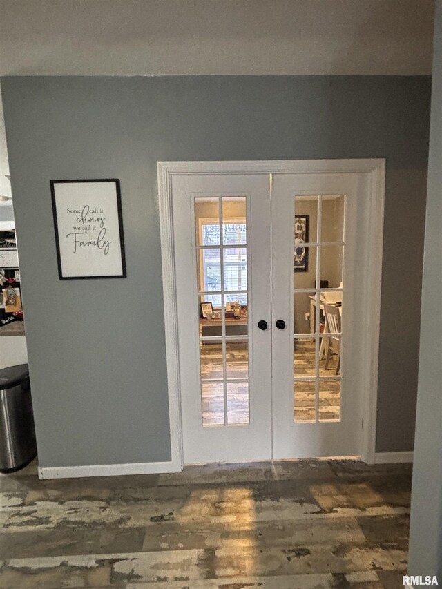 doorway to outside with french doors, baseboards, and dark wood-style flooring