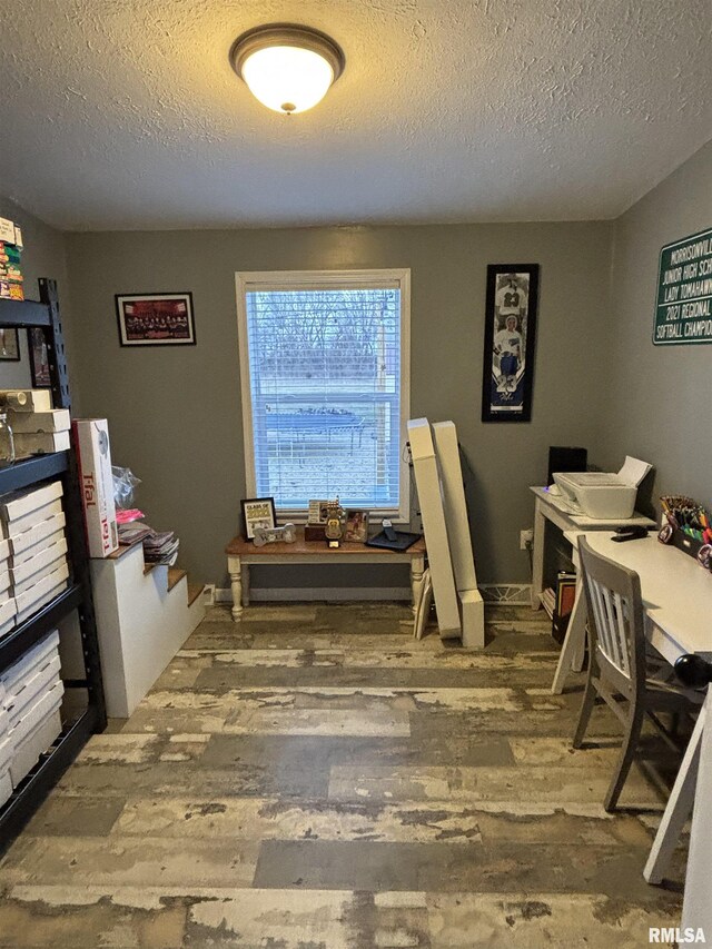 home office with a textured ceiling and wood finished floors