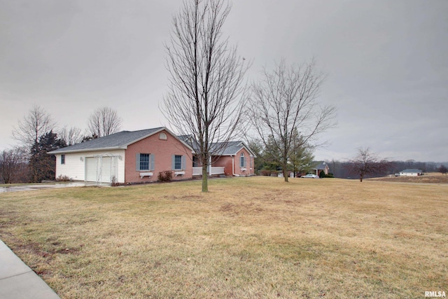 view of yard with driveway and an attached garage