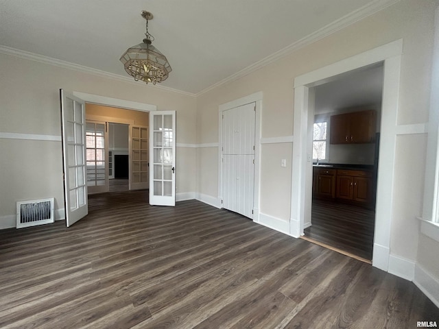 unfurnished dining area featuring a wealth of natural light, french doors, visible vents, and dark wood finished floors