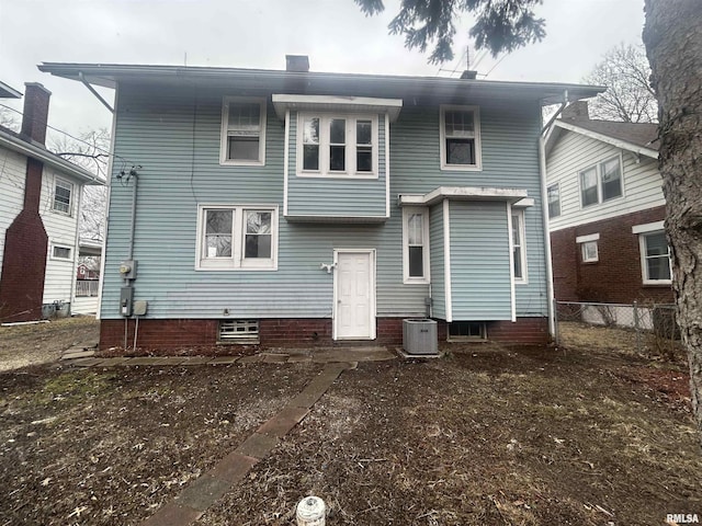 rear view of property featuring cooling unit and fence