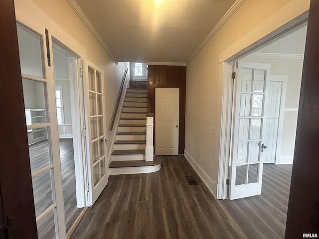 hall featuring ornamental molding, dark wood finished floors, and stairs