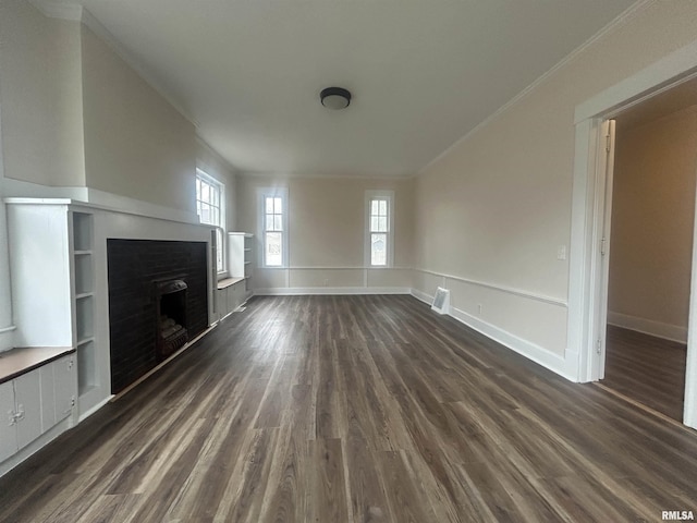 unfurnished living room featuring dark wood-style floors, baseboards, a fireplace, and ornamental molding