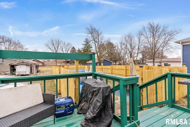 wooden deck with fence and area for grilling