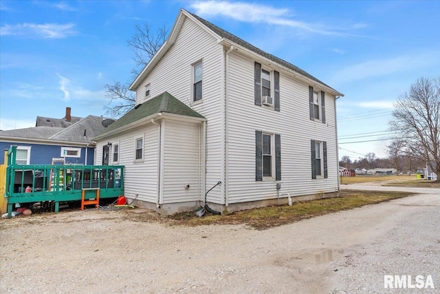 view of side of home with a wooden deck