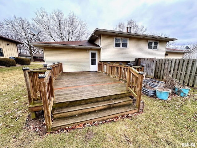 deck featuring a lawn and fence