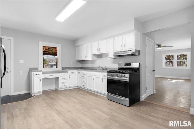 kitchen featuring ceiling fan, under cabinet range hood, white cabinetry, light wood-style floors, and stainless steel gas stove