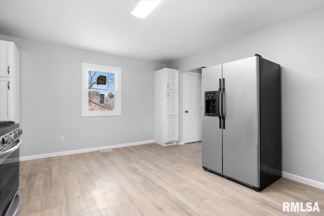 kitchen featuring light wood-style flooring, white cabinetry, and stainless steel appliances