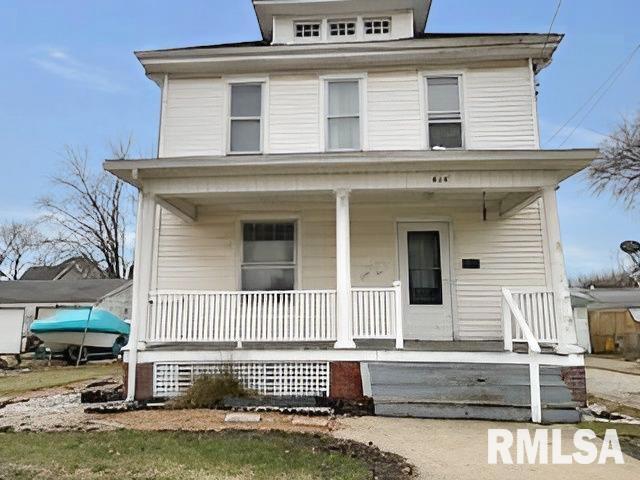 american foursquare style home with a porch