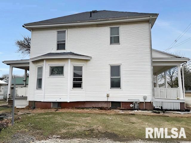 rear view of house with a yard