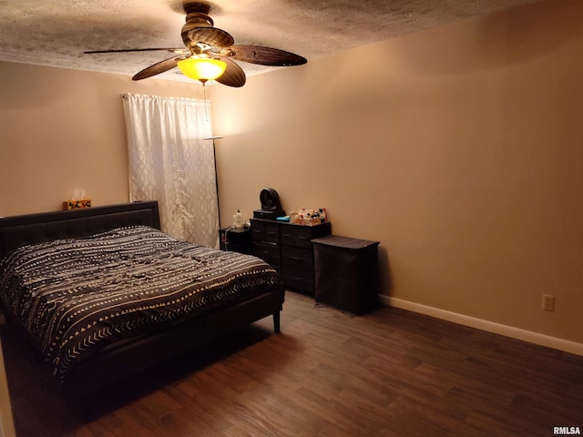 bedroom featuring a textured ceiling, wood finished floors, a ceiling fan, and baseboards