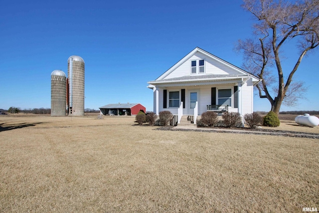 view of front of house with a porch and a front lawn