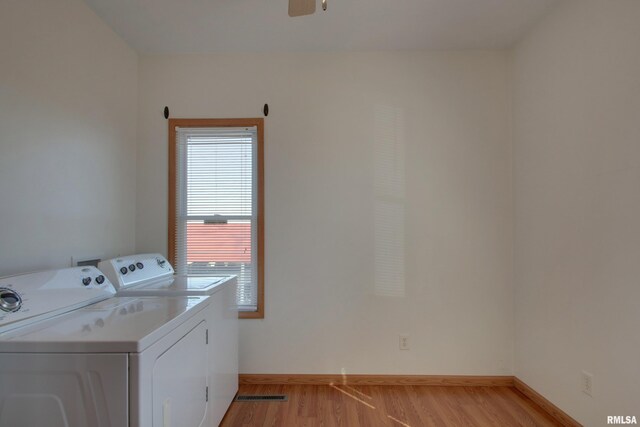 washroom featuring ceiling fan, light wood-style flooring, laundry area, baseboards, and washer and dryer