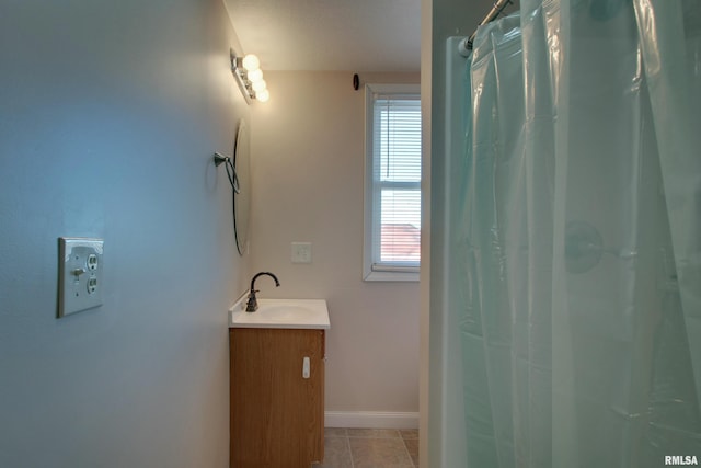 bathroom with a shower with shower curtain, vanity, baseboards, and tile patterned floors