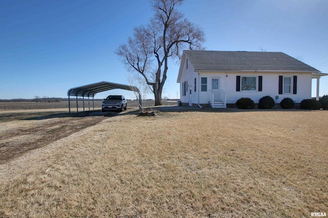 ranch-style house with a carport, driveway, and a front lawn