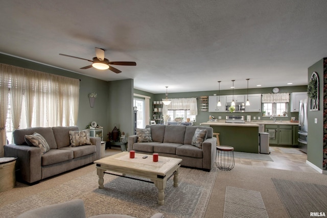 living room featuring a ceiling fan and recessed lighting