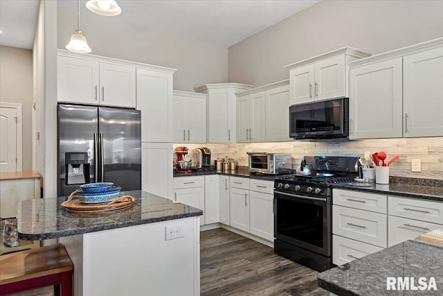 kitchen featuring decorative backsplash, white cabinets, dark wood-style flooring, and appliances with stainless steel finishes