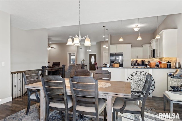 dining area featuring an inviting chandelier and dark wood-style floors