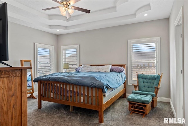 carpeted bedroom with recessed lighting, baseboards, a raised ceiling, and ceiling fan