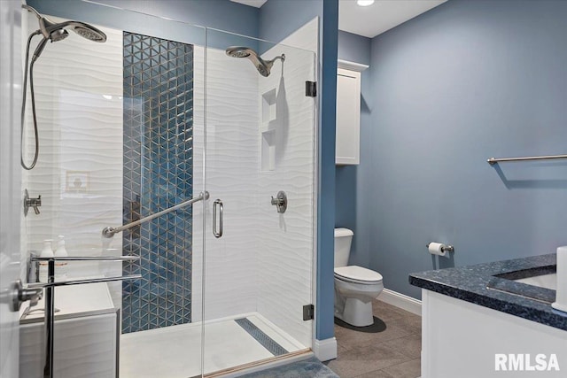 full bath featuring baseboards, toilet, a stall shower, tile patterned floors, and vanity