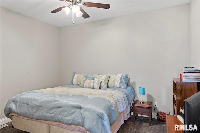 bedroom with a ceiling fan, baseboards, and carpet floors