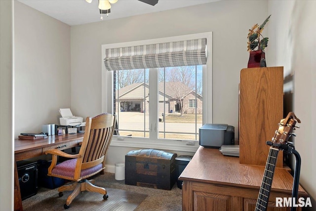 office space with baseboards, ceiling fan, and carpet floors