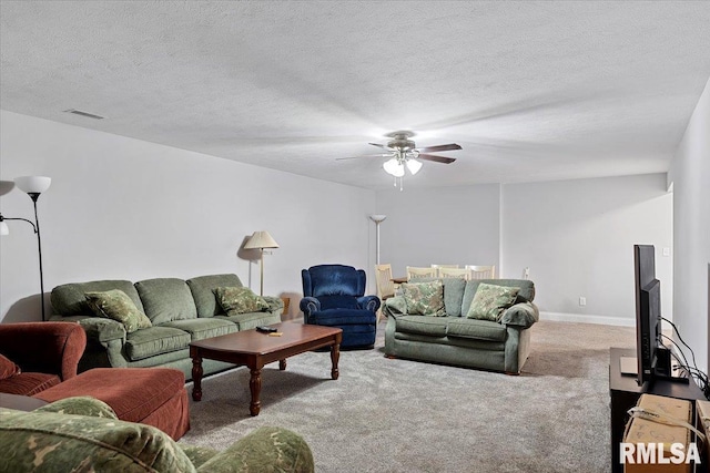 carpeted living room featuring ceiling fan, baseboards, visible vents, and a textured ceiling