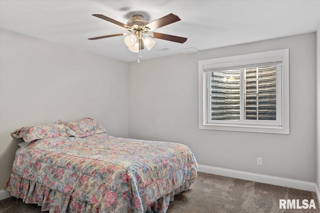 carpeted bedroom featuring visible vents, baseboards, and a ceiling fan