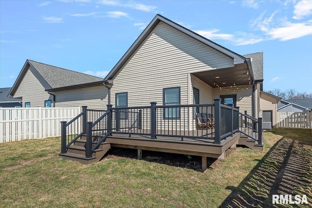 rear view of property with a yard, a fenced backyard, and roof with shingles