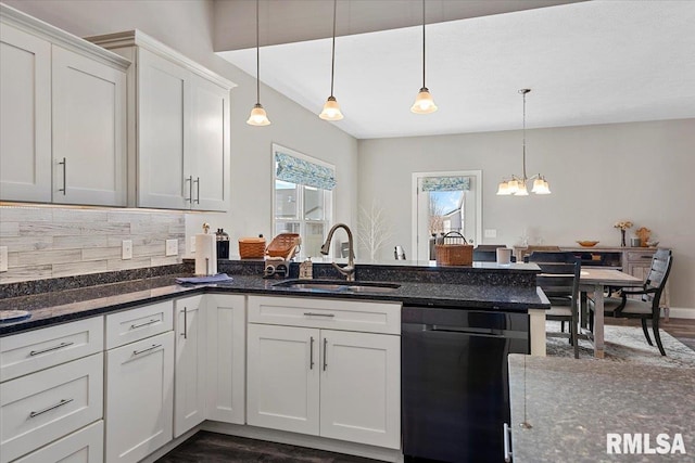 kitchen with a sink, tasteful backsplash, black dishwasher, dark wood-style floors, and white cabinets